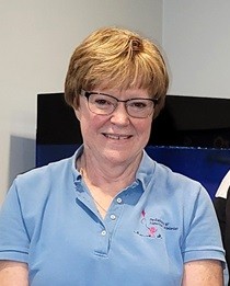 staff standing and smiling